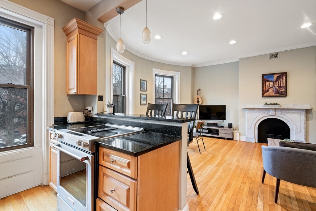 32 Union Park, Unit 2 Boston, MA 02118 - Photo 11 of 19 a kitchen with stainless steel appliances granite countertop a stove and a refrigerator