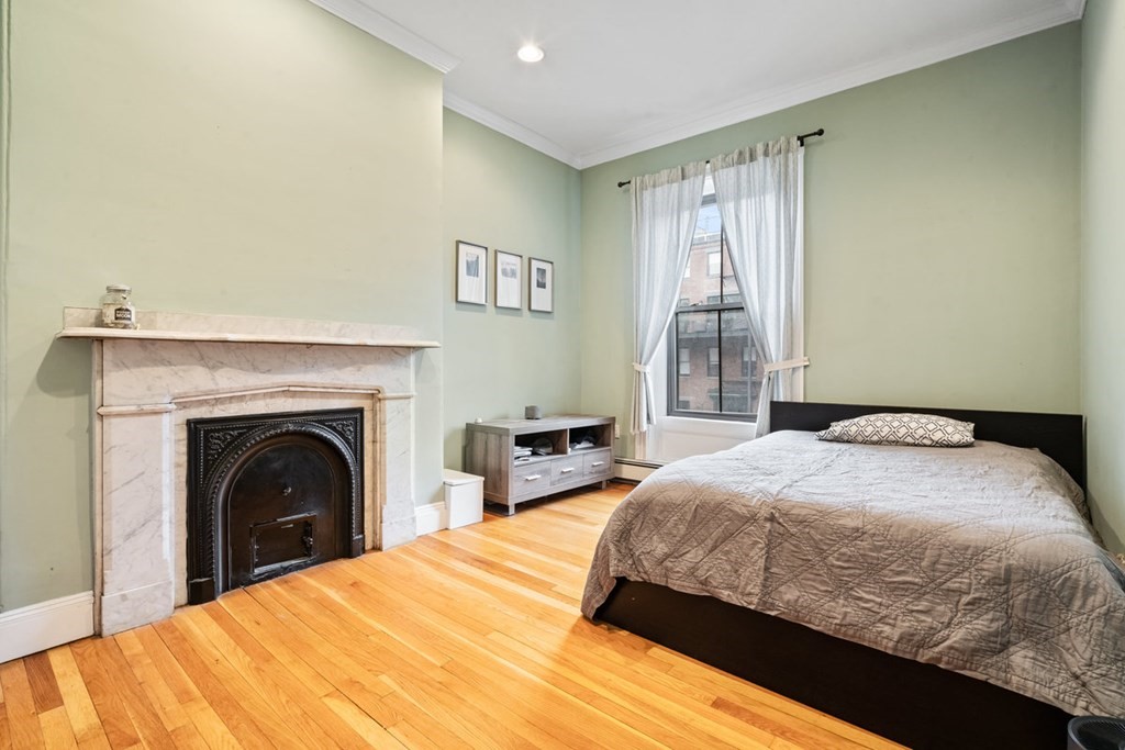 32 Union Park, Unit 2 Boston, MA 02118 - Photo 12 of 19 a bedroom with a bed and a fireplace