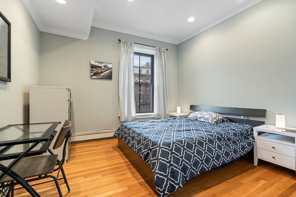 32 Union Park, Unit 2 Boston, MA 02118 - Photo 13 of 19 a bedroom with a bed and wooden floor