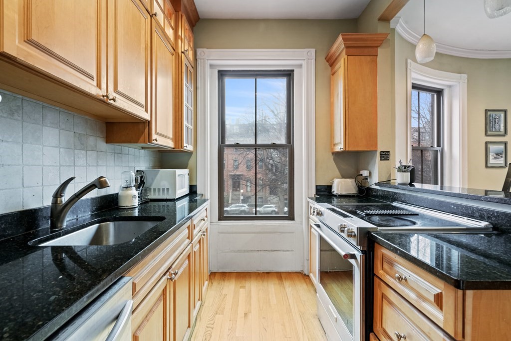 32 Union Park, Unit 2 Boston, MA 02118 - Photo 10 of 19 a kitchen with granite countertop a sink stove and cabinets