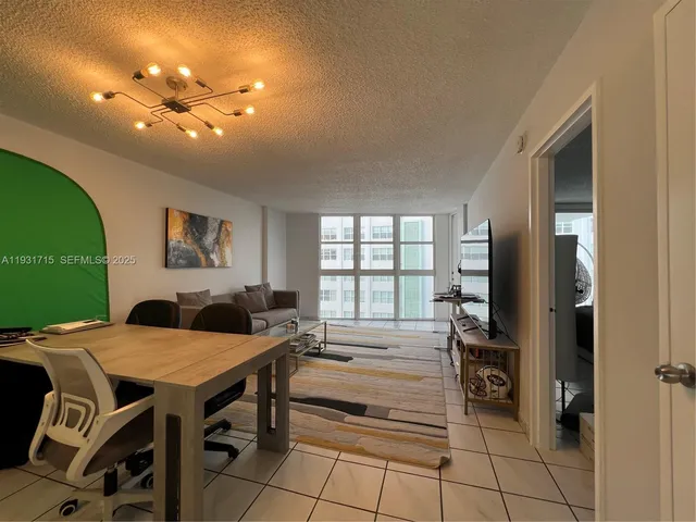 a view of a dining room with furniture and a chandelier