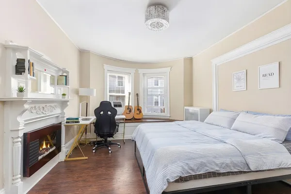 a bedroom with a bed a table and chair