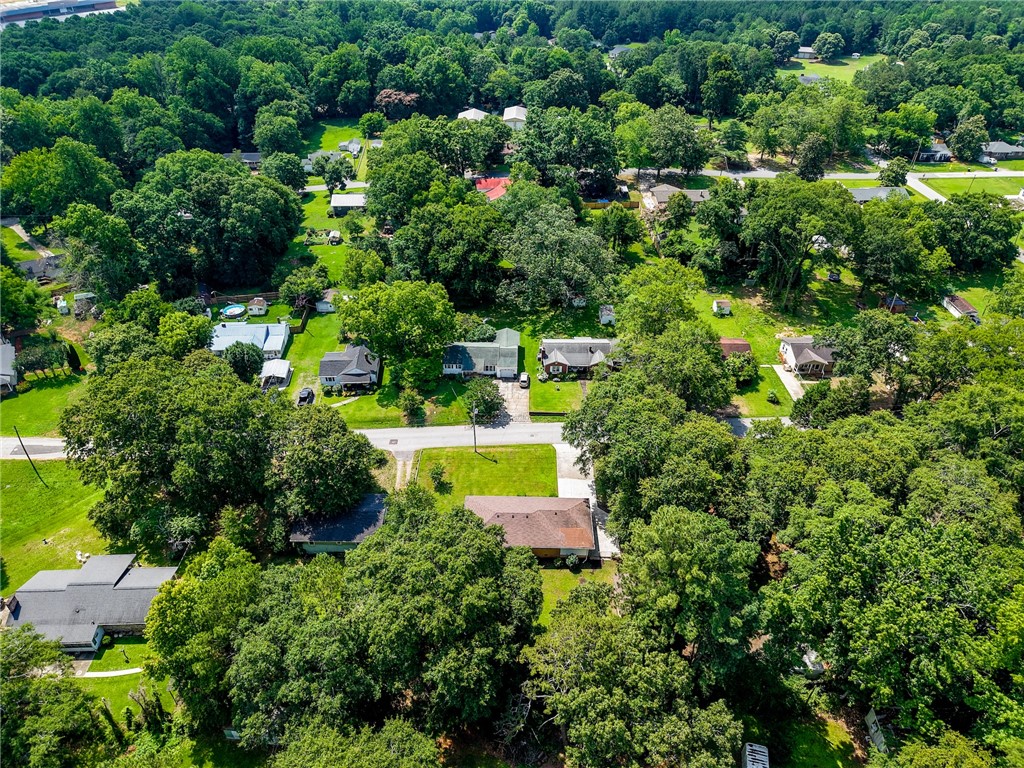 12 Dendy Street Pelzer, SC 29669 - Photo 31 of 31 An aerial perspective reveals a verdant, tree-lined neighborhood with scattered homes, offering tranquil views.