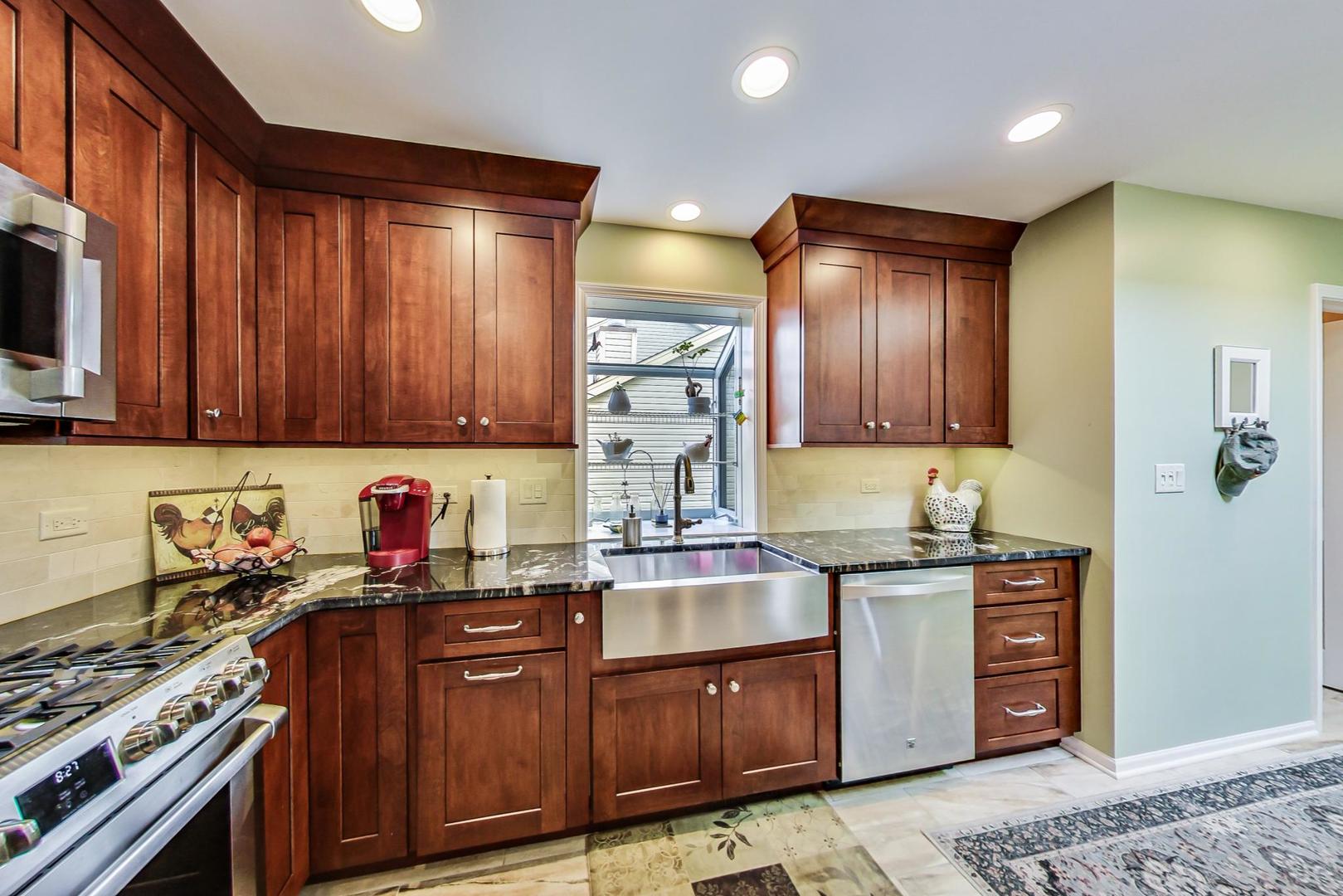 N440 Kimball Road Winfield, IL 60190 - Photo 6 of 21 a kitchen with stainless steel appliances granite countertop wooden cabinets a stove top oven a sink and dishwasher