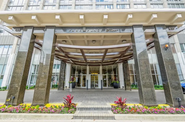 a front view of a building with flowers