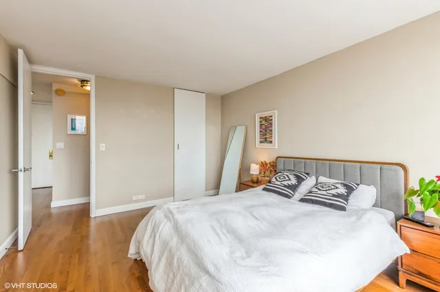 a bedroom with a bed and wooden floor