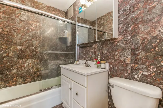 a bathroom with a sink toilet and shower