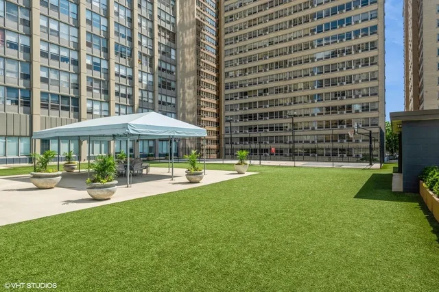 a swimming pool with outdoor seating and buildings view