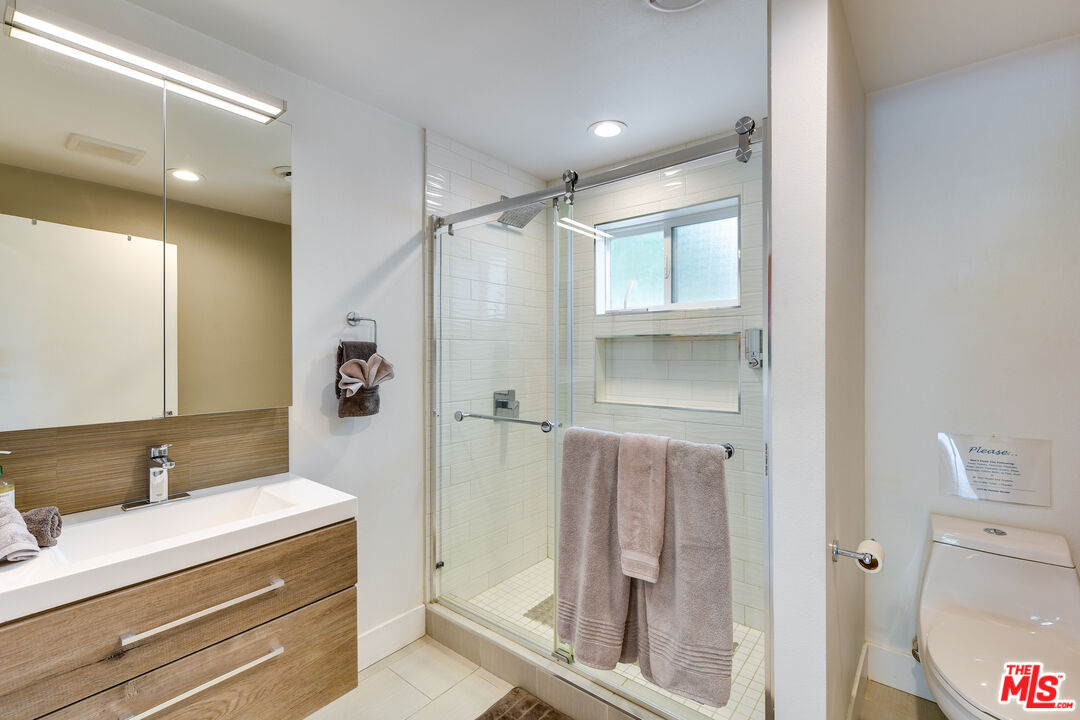 2146 North Blando Road Palm Springs, CA 92262 - Photo 15 of 31 a bathroom with a shower sink and mirror