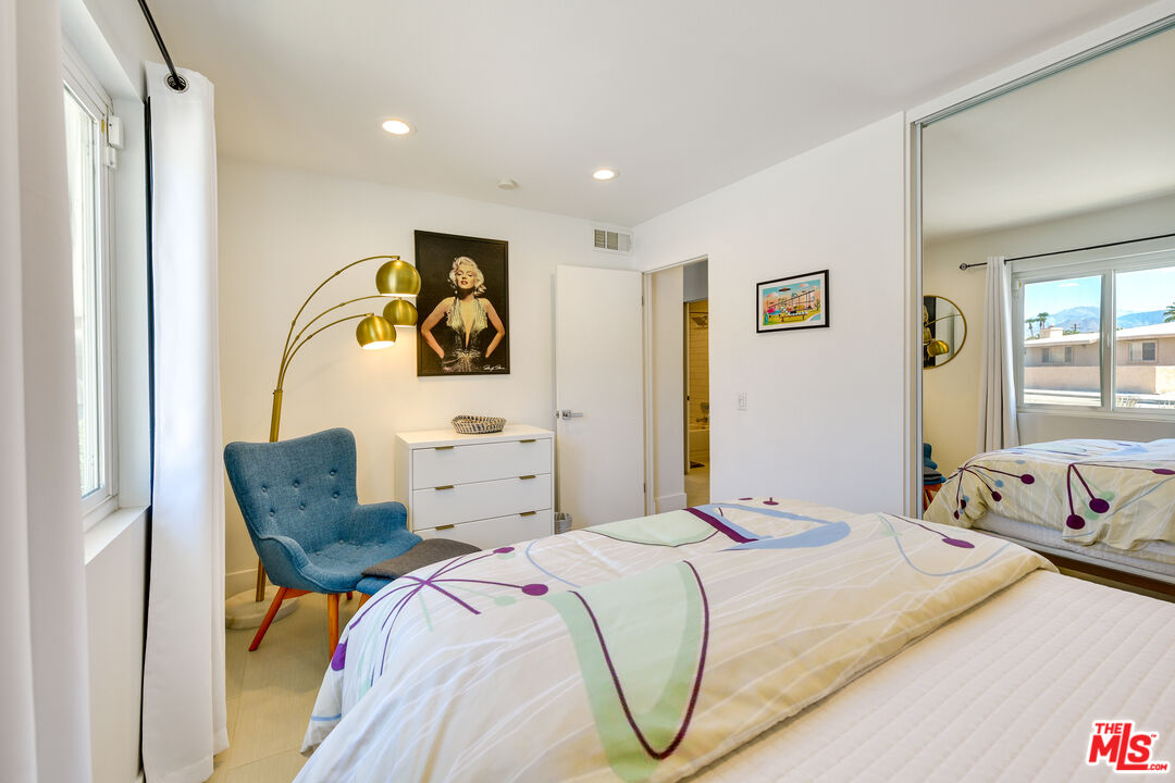 2146 North Blando Road Palm Springs, CA 92262 - Photo 16 of 31 a bedroom with a bed and a couch with window