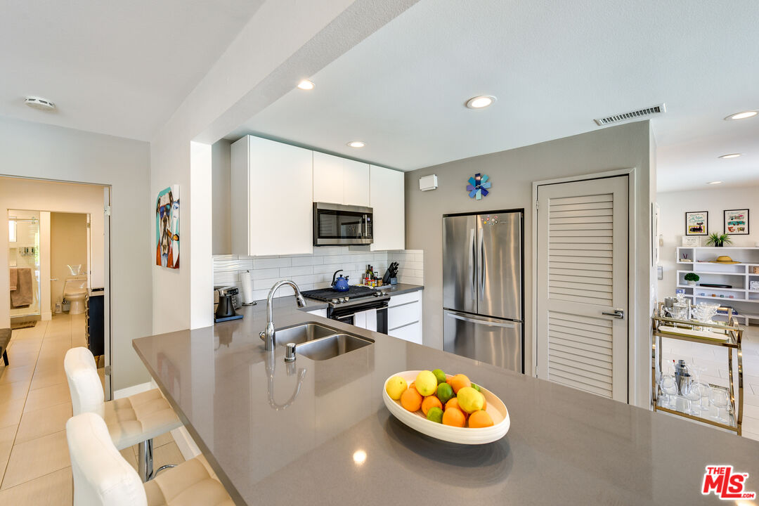 2146 North Blando Road Palm Springs, CA 92262 - Photo 8 of 31 a living room with furniture and a flat screen tv