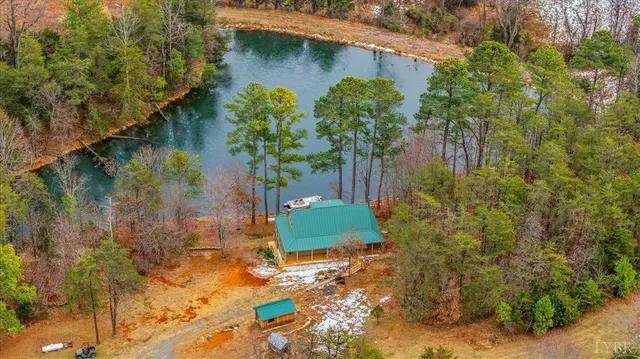 a living room with fireplace furniture and a large window