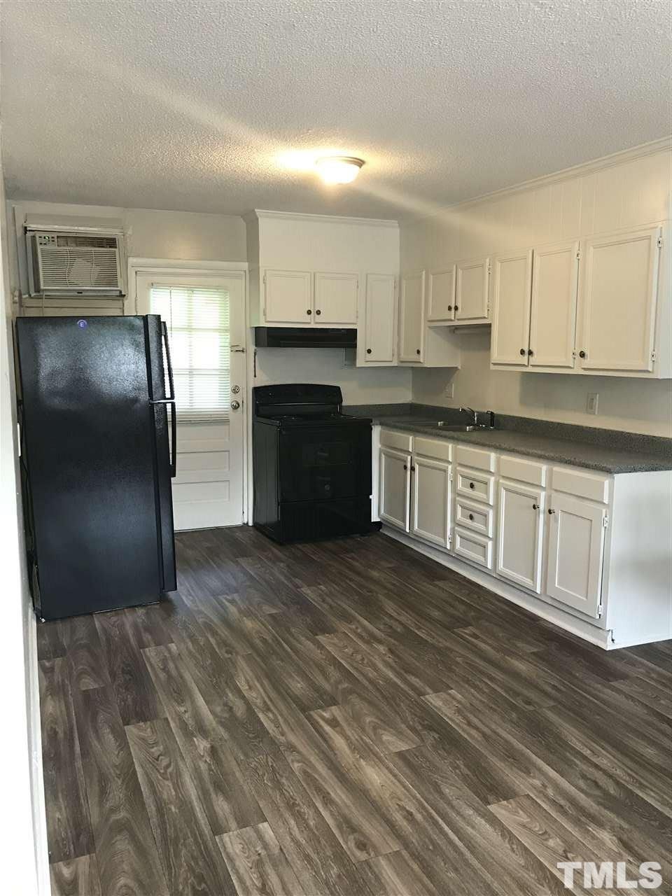 1400 Creech Road, Unit 4 Garner, NC 27529 - Photo 2 of 13 a kitchen with stainless steel appliances granite countertop a refrigerator a stove a sink and white cabinets