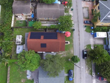 an aerial view of a house with pool big yard and outdoor seating