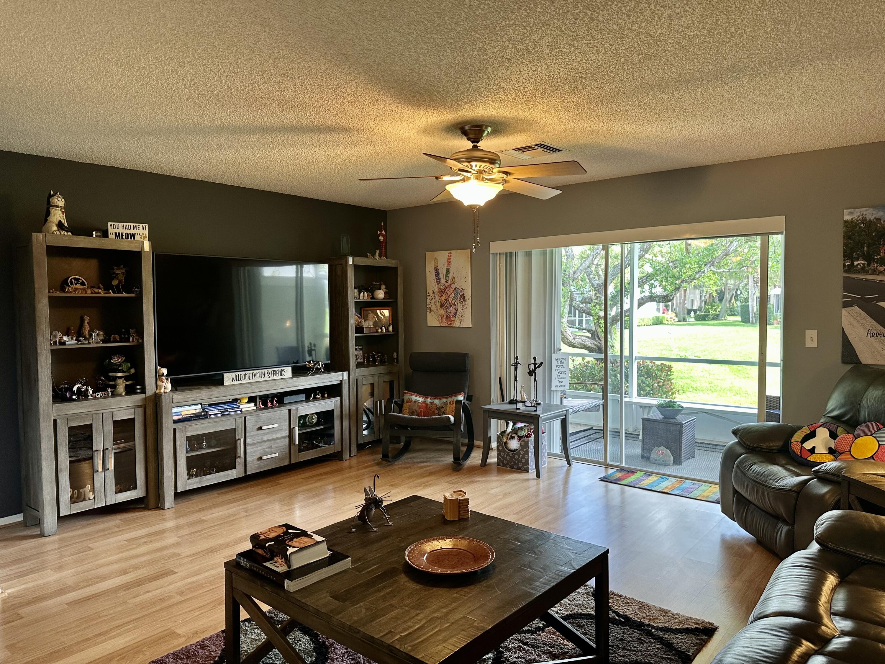 188 Timberwalk Trail Jupiter, FL 33458 - Photo 6 of 6 a living room with furniture and a flat screen tv