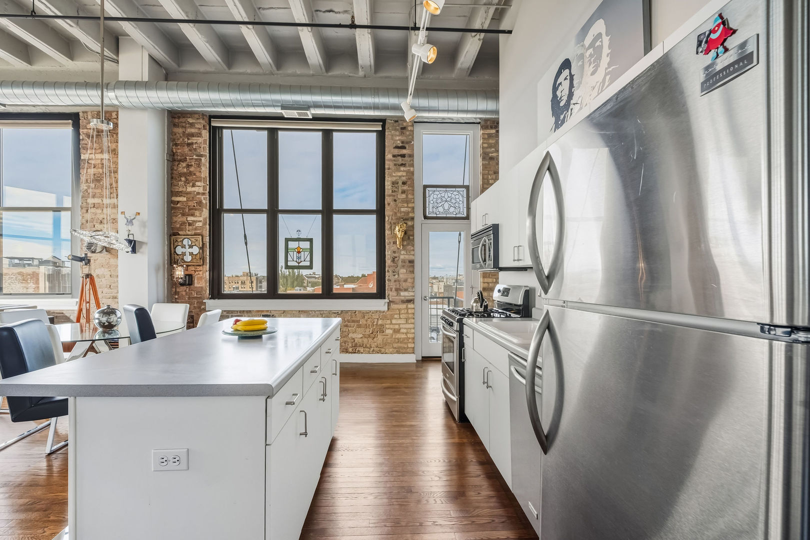 1601 West School Street, Unit 511 Chicago, IL 60657 - Photo 9 of 23 a kitchen with stainless steel appliances a sink stove and a refrigerator