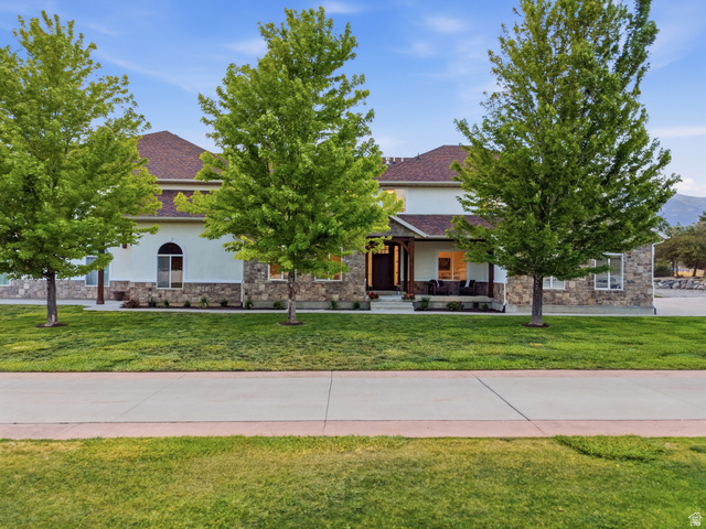 702 Alpine Highway Alpine, UT 84004 - Photo 5 of 83 Exterior residence featuring a combination of stucco and stone siding, gabled roofline, and a covered porch entry