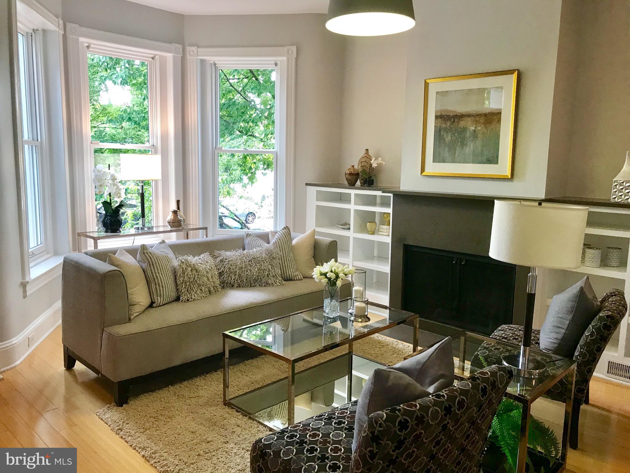 906 G Street Southeast Washington, DC 20003 - Photo 2 of 28 a living room with furniture a fireplace and a large window