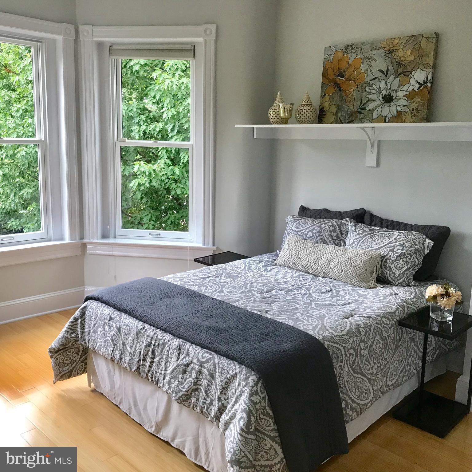 906 G Street Southeast Washington, DC 20003 - Photo 14 of 28 a bed sitting in a bedroom next to a window