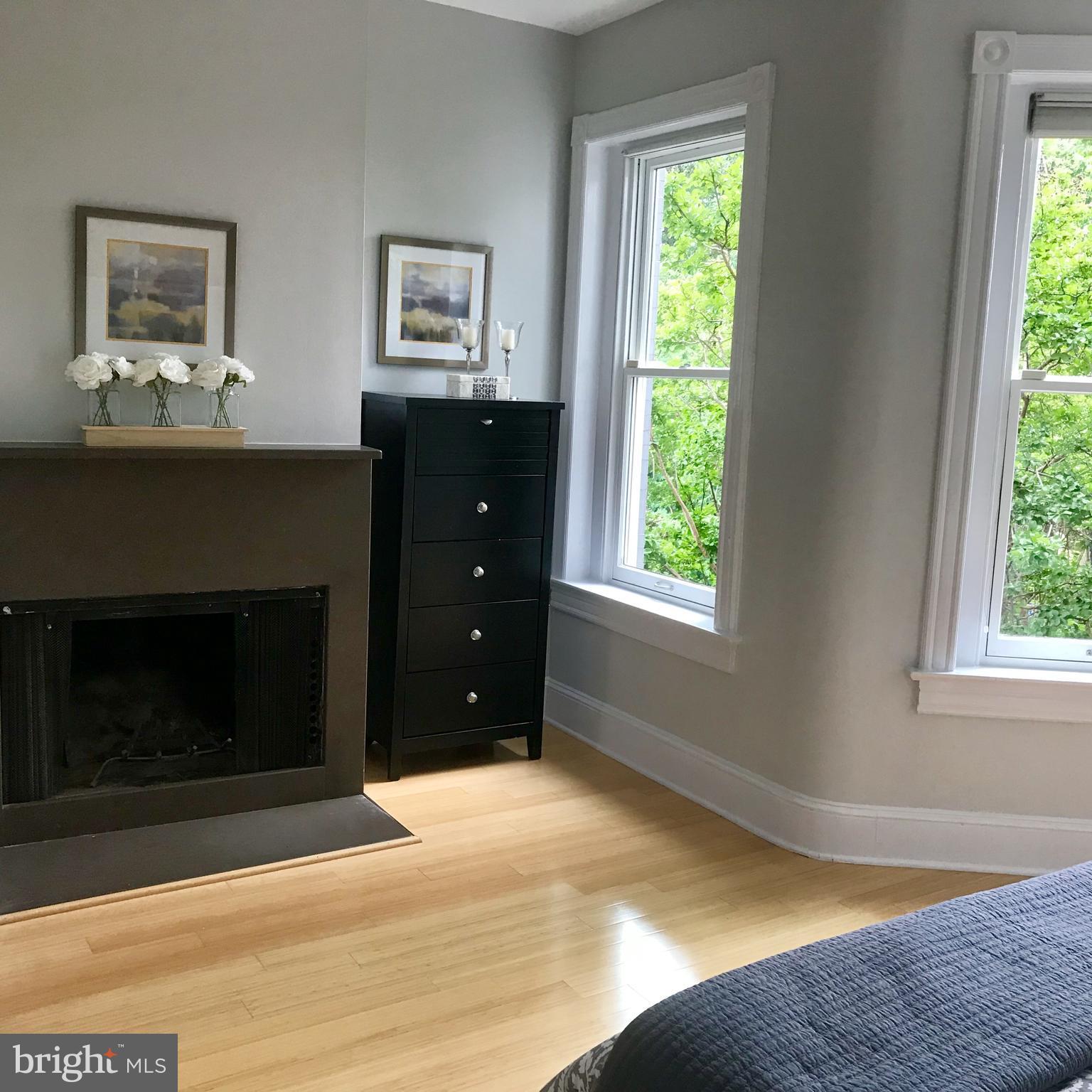 906 G Street Southeast Washington, DC 20003 - Photo 15 of 28 a bedroom with a bed and a fireplace