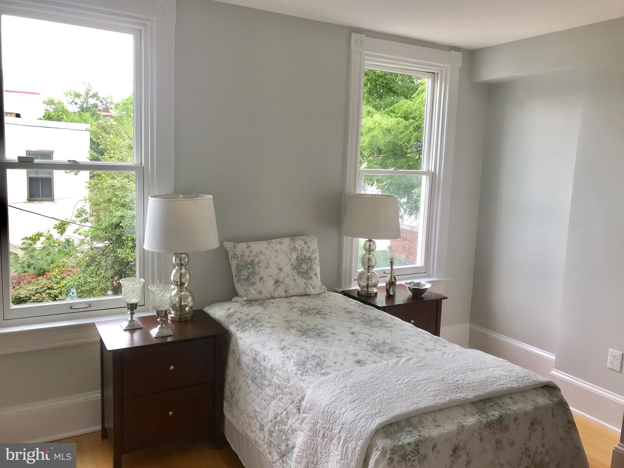 906 G Street Southeast Washington, DC 20003 - Photo 18 of 28 a bedroom with a bed and a large window