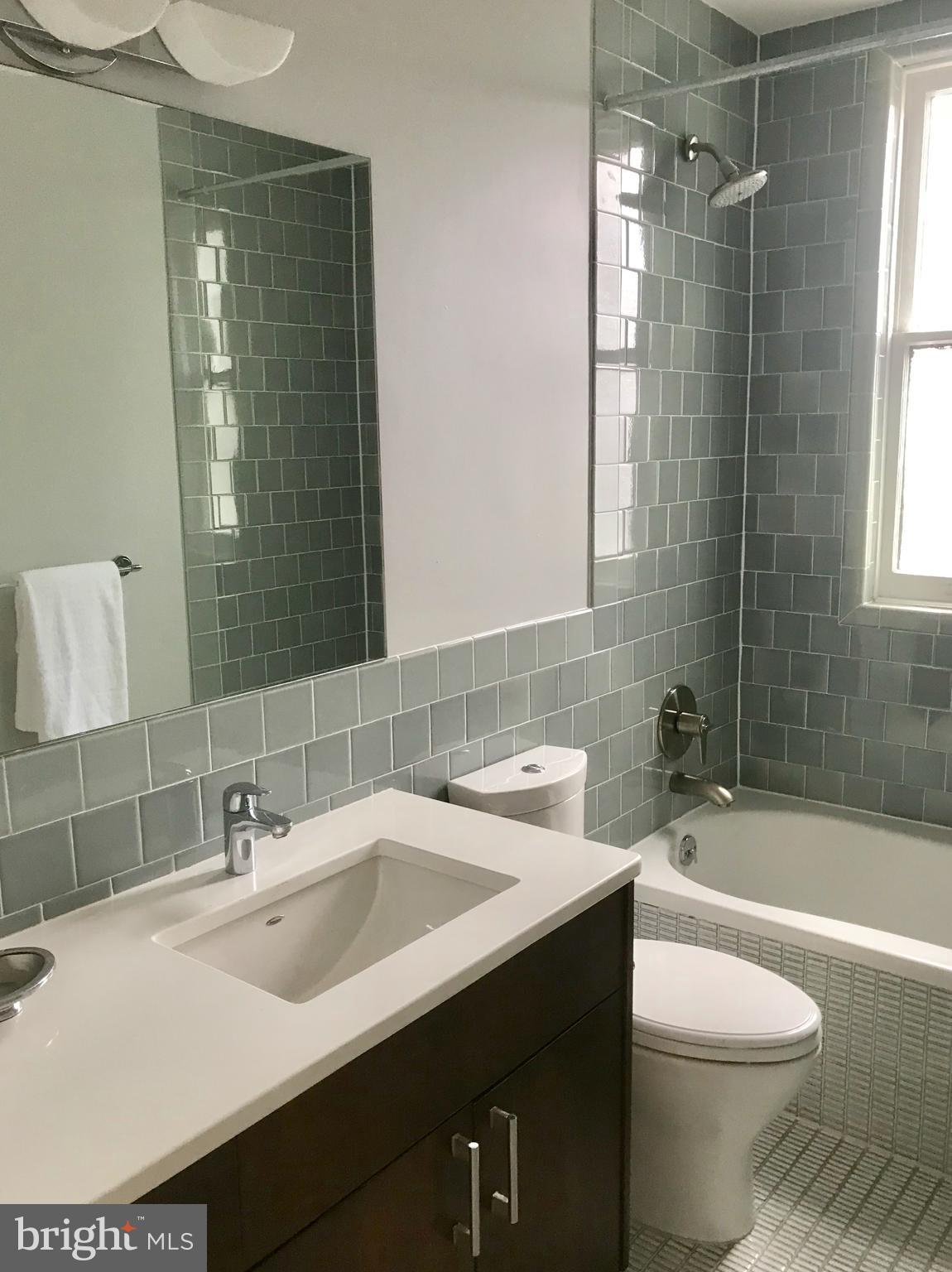 906 G Street Southeast Washington, DC 20003 - Photo 19 of 28 a bathroom with a sink toilet vanity and shower