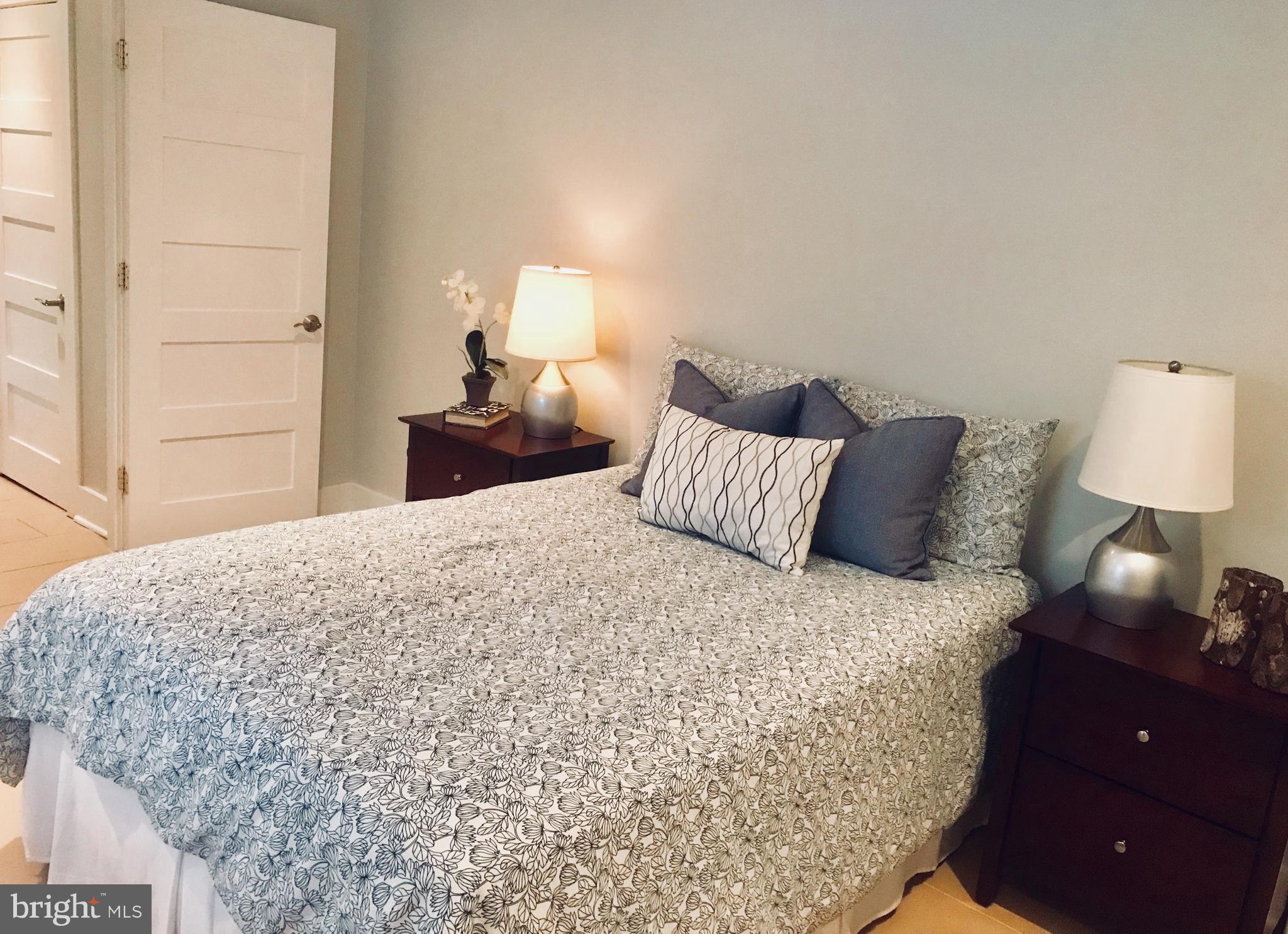 906 G Street Southeast Washington, DC 20003 - Photo 20 of 28 a bedroom with a bed and a lamp