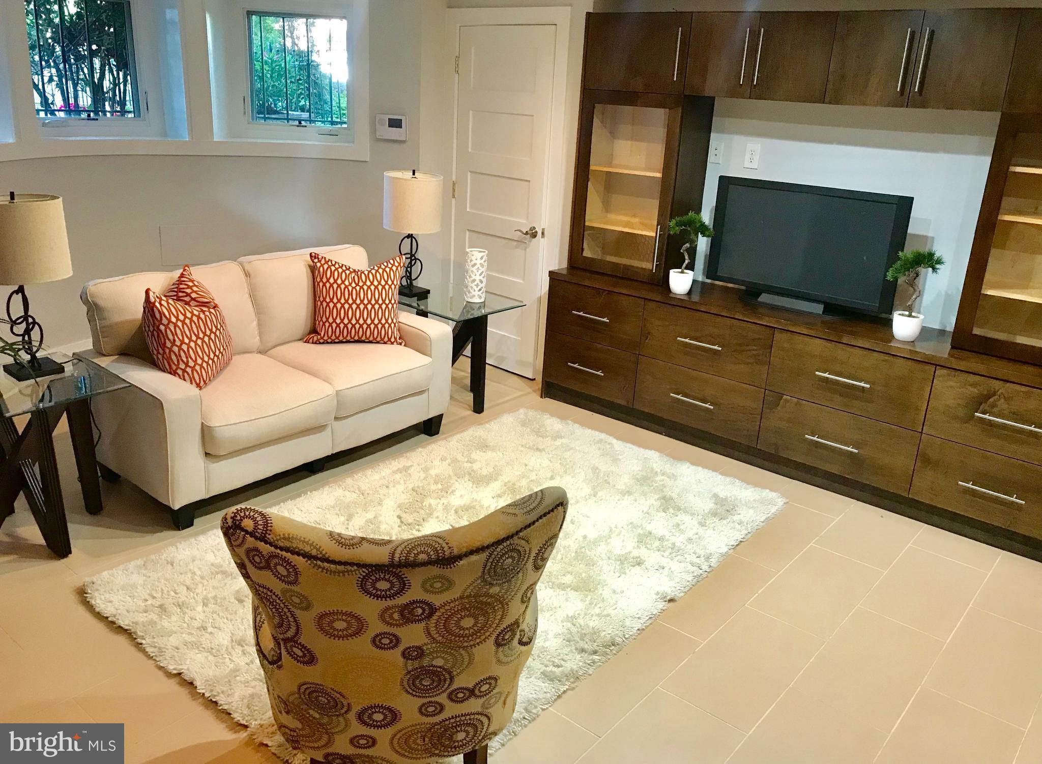 906 G Street Southeast Washington, DC 20003 - Photo 22 of 28 a living room with furniture and a flat screen tv