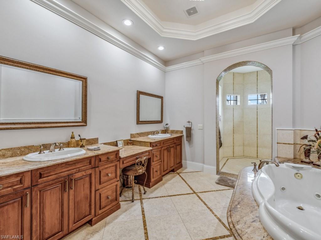 16509 Cellini Lane Naples, FL 34110 - Photo 15 of 49 a spacious bathroom with a double vanity sink and a mirror