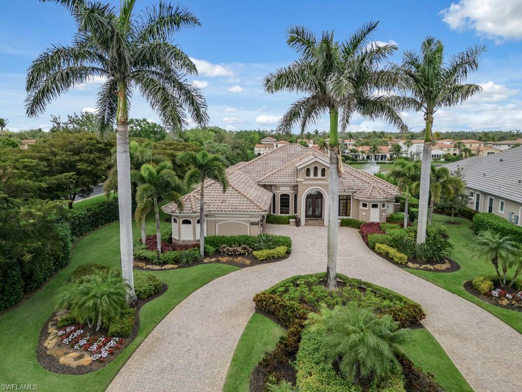 16509 Cellini Lane Naples, FL 34110 - Photo 22 of 49 a front view of a house with a garden