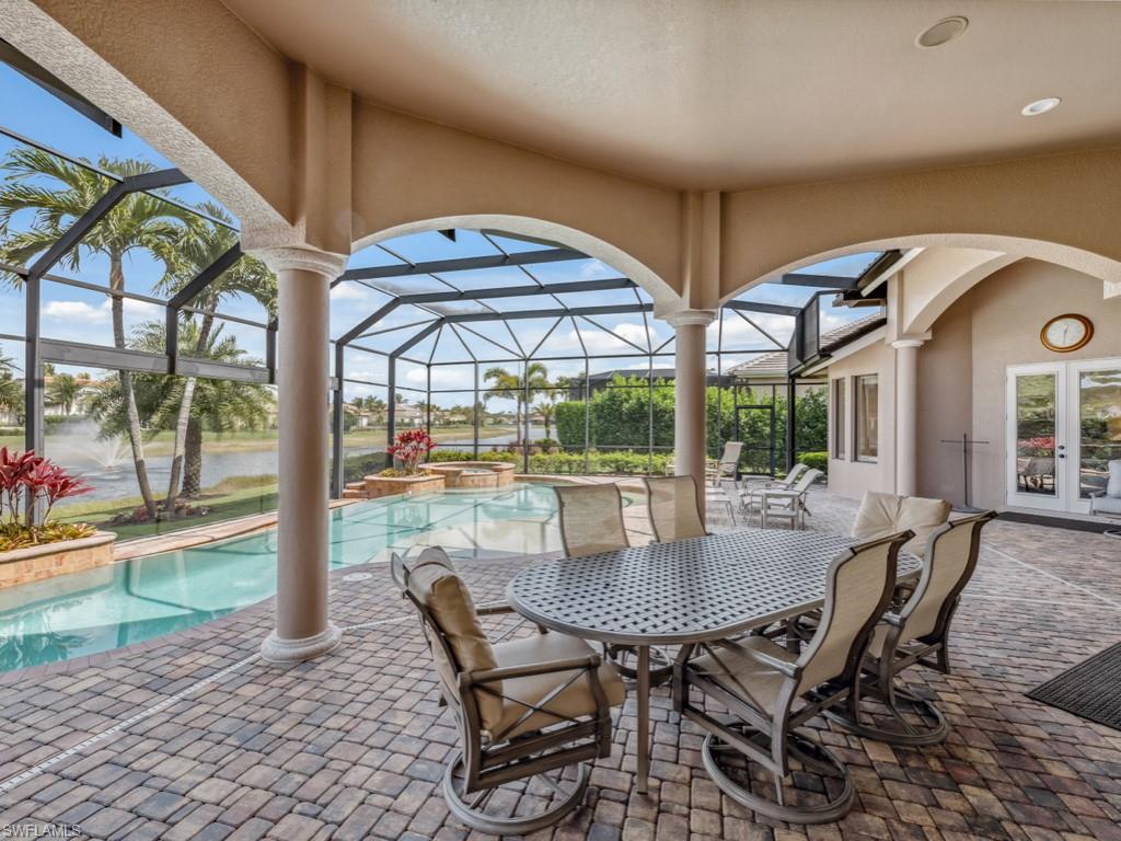 16509 Cellini Lane Naples, FL 34110 - Photo 3 of 49 a view of a dining room with furniture wooden floor and chandelier