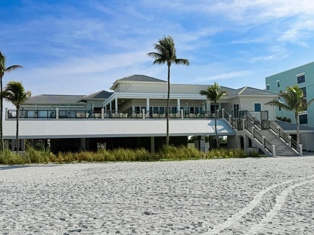 16509 Cellini Lane Naples, FL 34110 - Photo 47 of 49 a view of a big house with a big yard and large tree