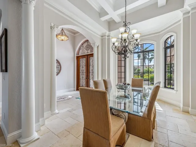 a view of a dining room with furniture and a chandelier