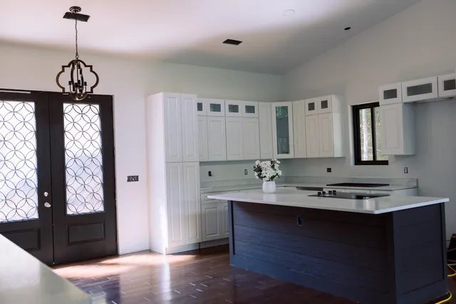 a view of a room with wooden floor and windows