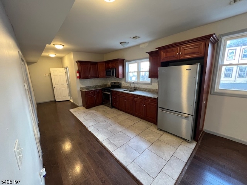 142 Sunset Avenue, Unit 1 Newark, NJ 07106 - Photo 2 of 10 a kitchen with refrigerator and window