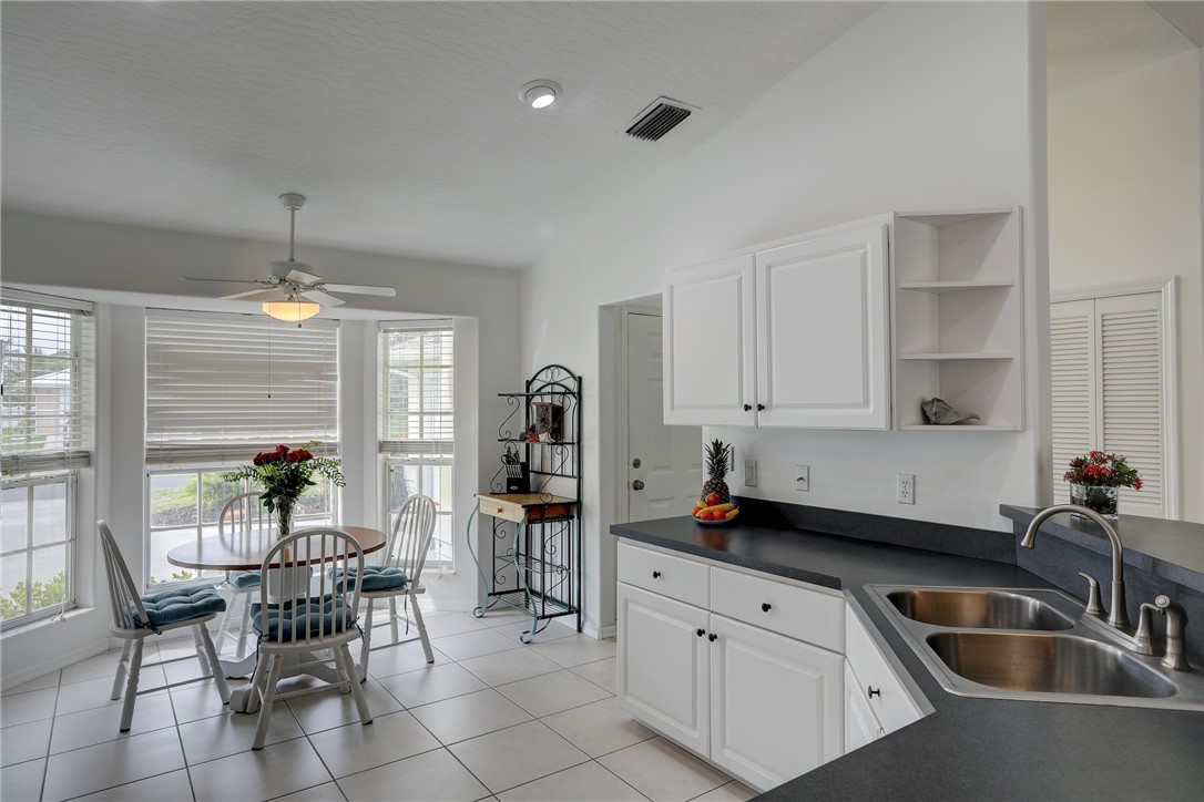 406 Perch Lane Sebastian, FL 32958 - Photo 11 of 27 a kitchen that has a table and chairs in it