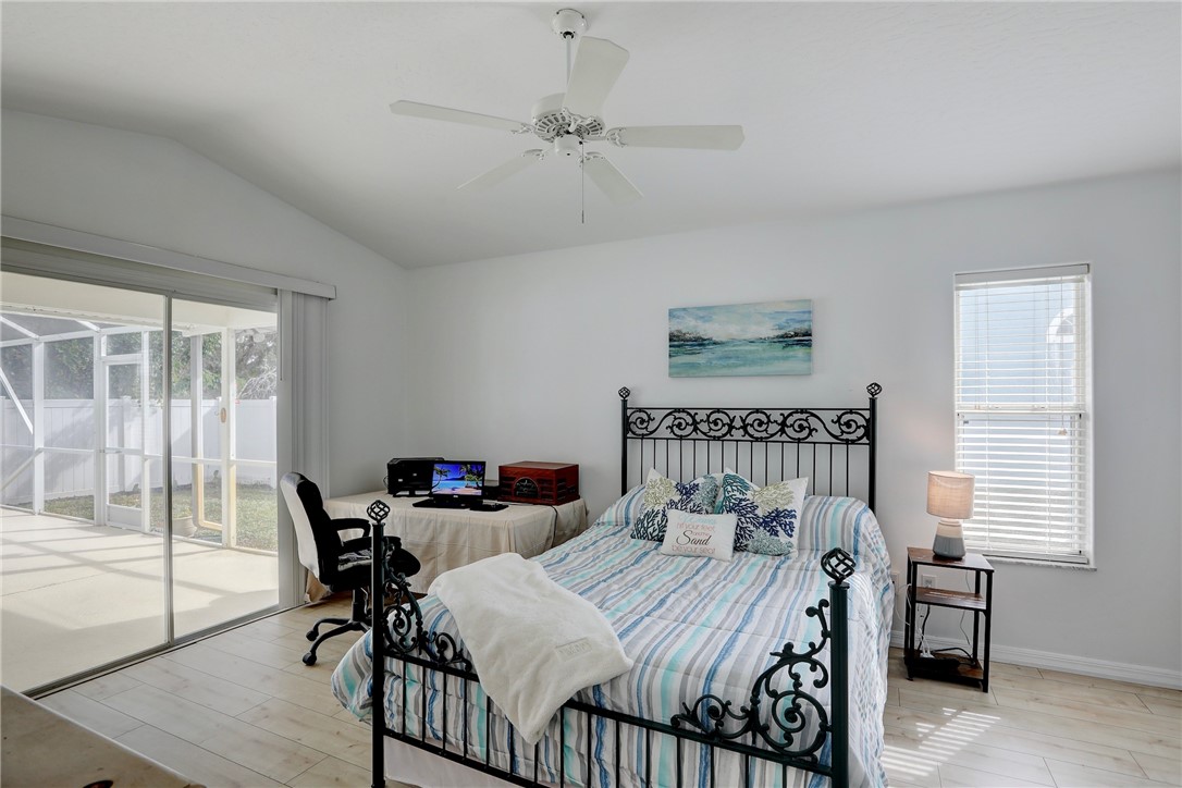 406 Perch Lane Sebastian, FL 32958 - Photo 13 of 27 a bedroom with a bed and a table in it