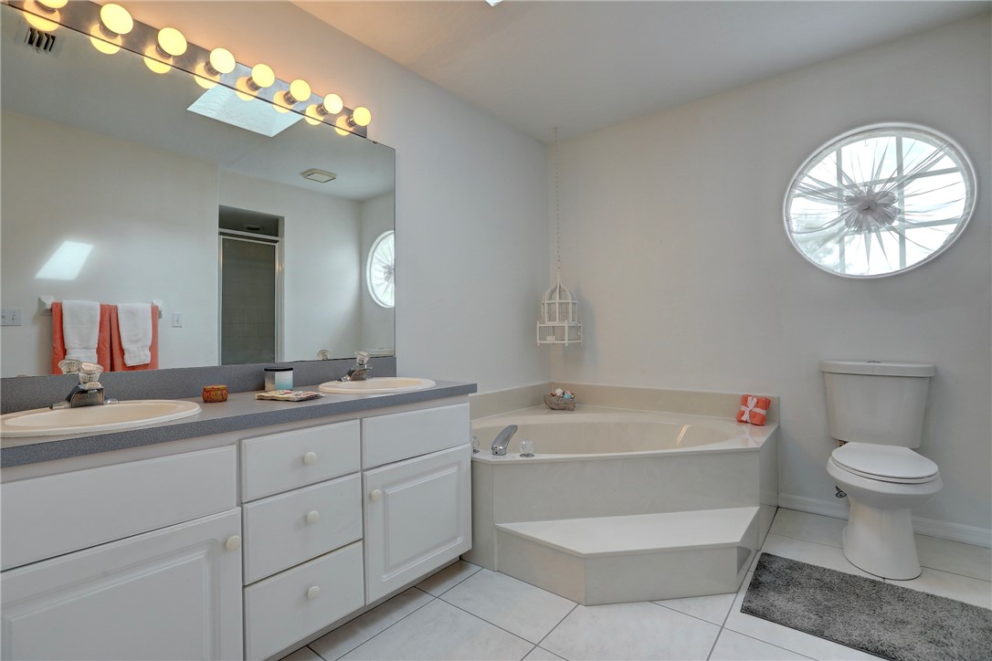406 Perch Lane Sebastian, FL 32958 - Photo 14 of 27 a bathroom with a toilet a sink and a mirror