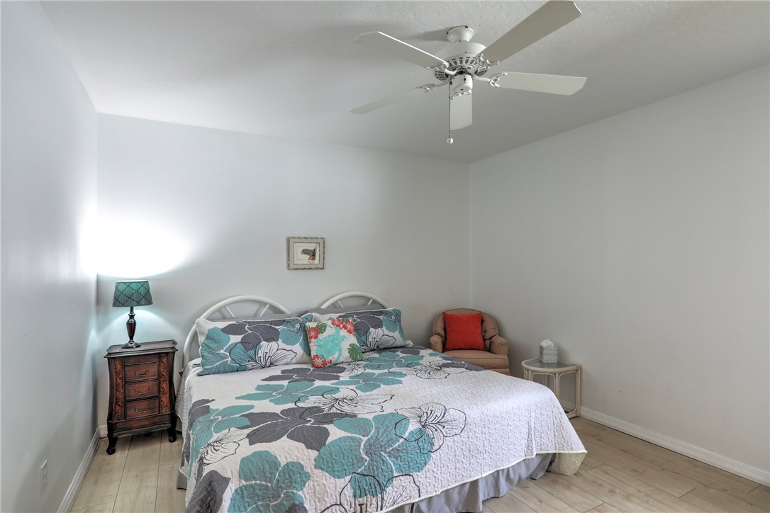 406 Perch Lane Sebastian, FL 32958 - Photo 16 of 27 a bedroom with a bed and a chandelier