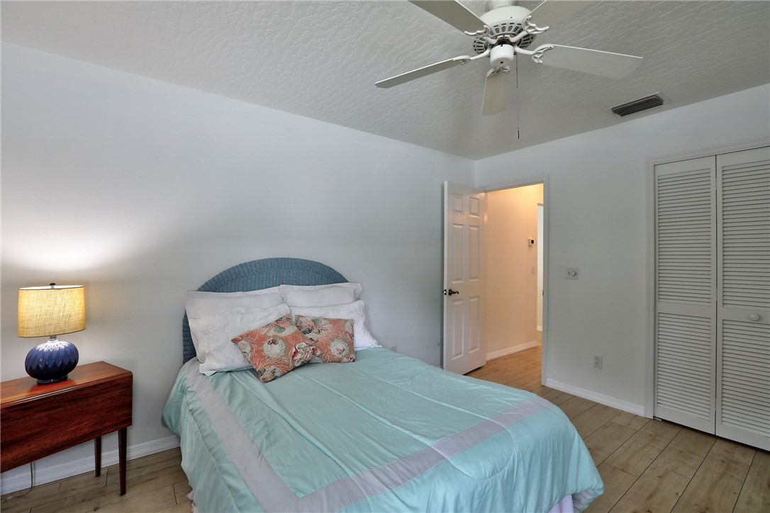 406 Perch Lane Sebastian, FL 32958 - Photo 18 of 27 a bedroom with a bed and wooden floor