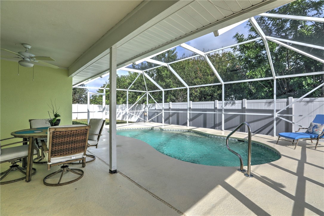 406 Perch Lane Sebastian, FL 32958 - Photo 20 of 27 a view of a swimming pool with a table and chairs