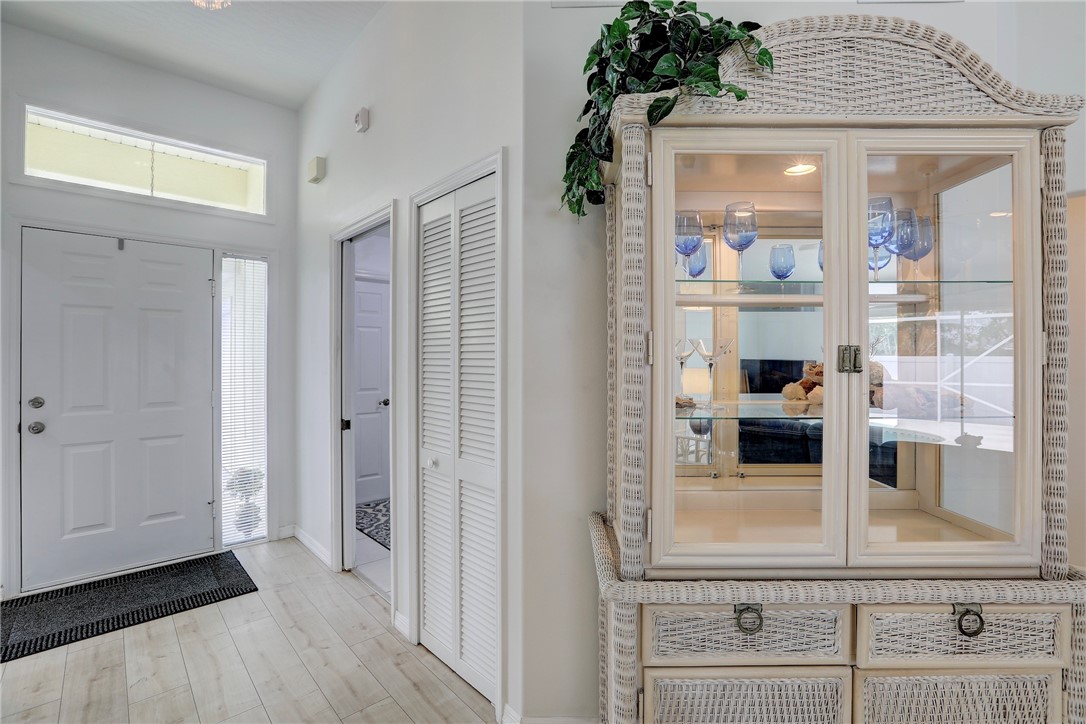 406 Perch Lane Sebastian, FL 32958 - Photo 3 of 27 a view of a hallway with wooden floor and cabinet