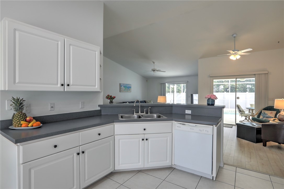 406 Perch Lane Sebastian, FL 32958 - Photo 10 of 27 a kitchen with white cabinets and sink