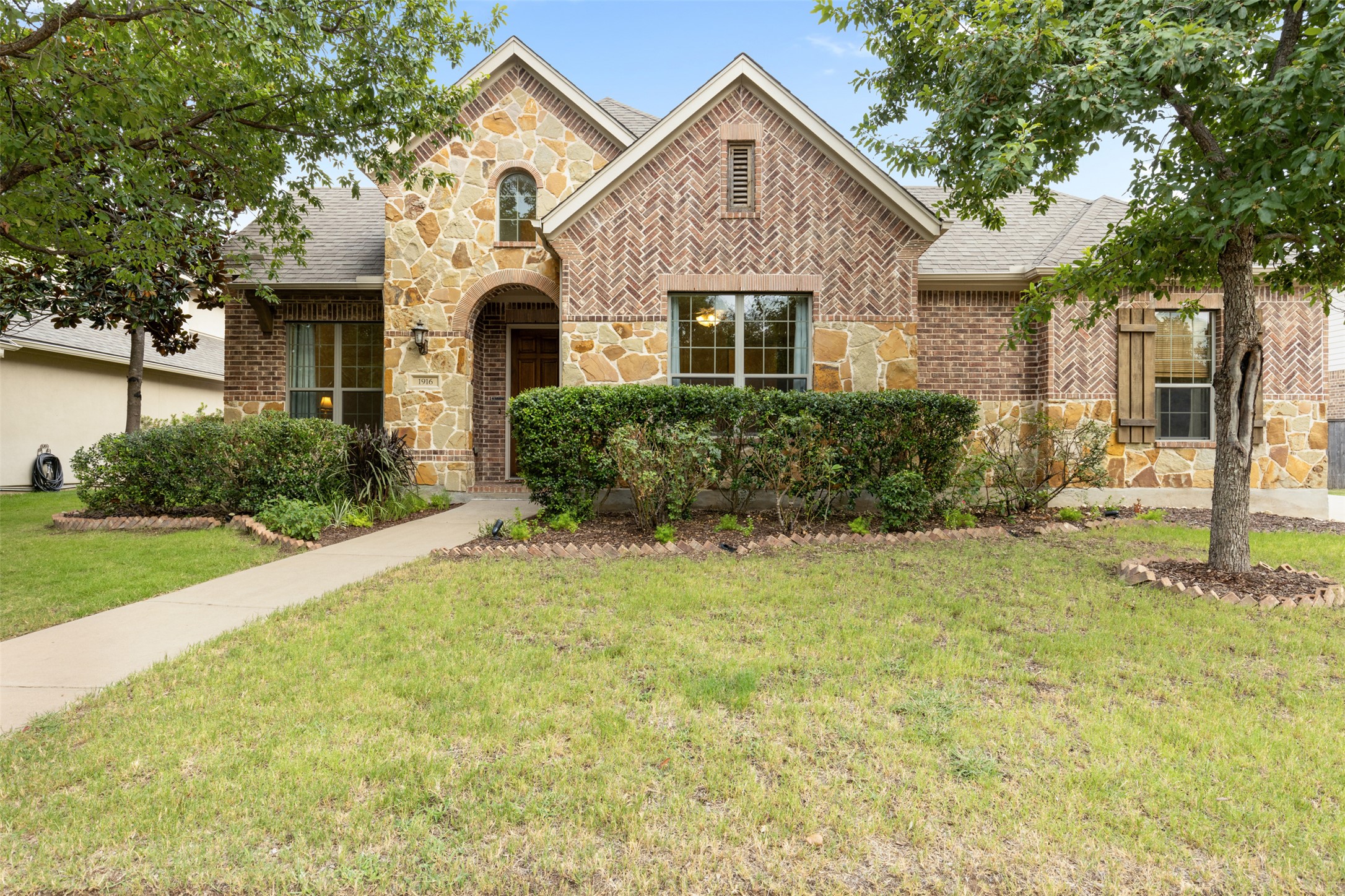 1916 Buffalo Speedway Leander, TX 78641 - Photo 2 of 31 a front view of a house with garden