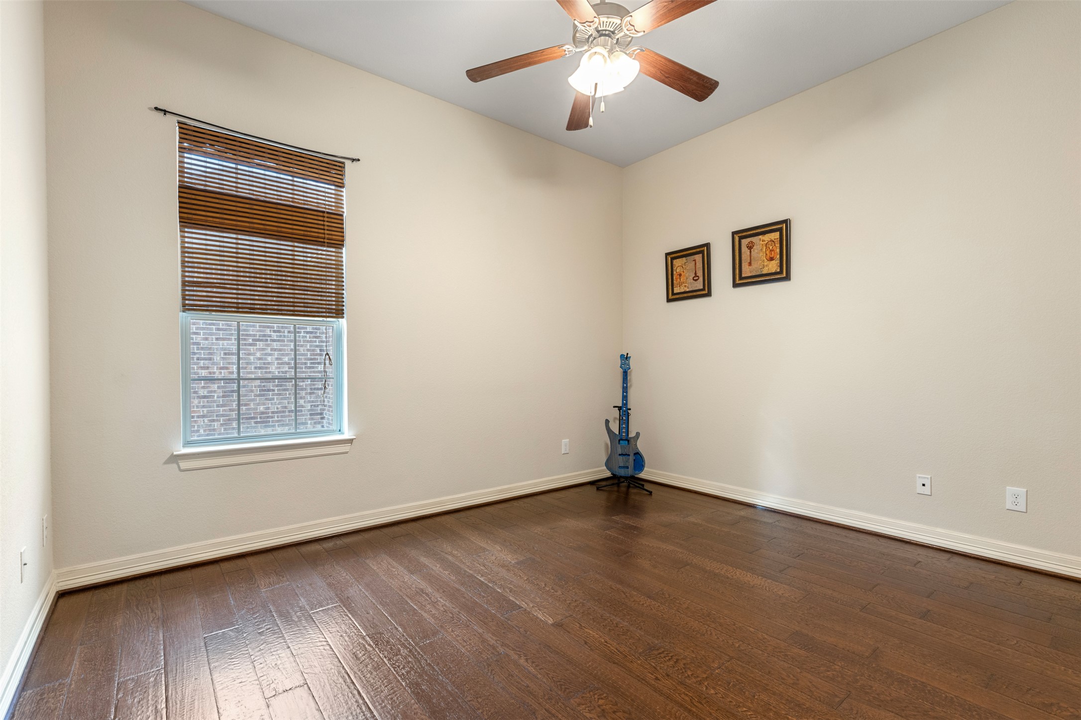 1916 Buffalo Speedway Leander, TX 78641 - Photo 21 of 31 a view of an empty room with wooden floor and a window