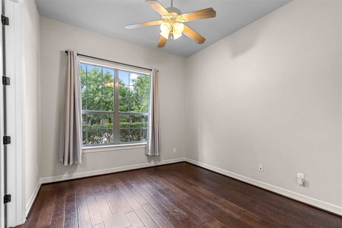 1916 Buffalo Speedway Leander, TX 78641 - Photo 22 of 30 a view of an empty room with wooden floor and a window