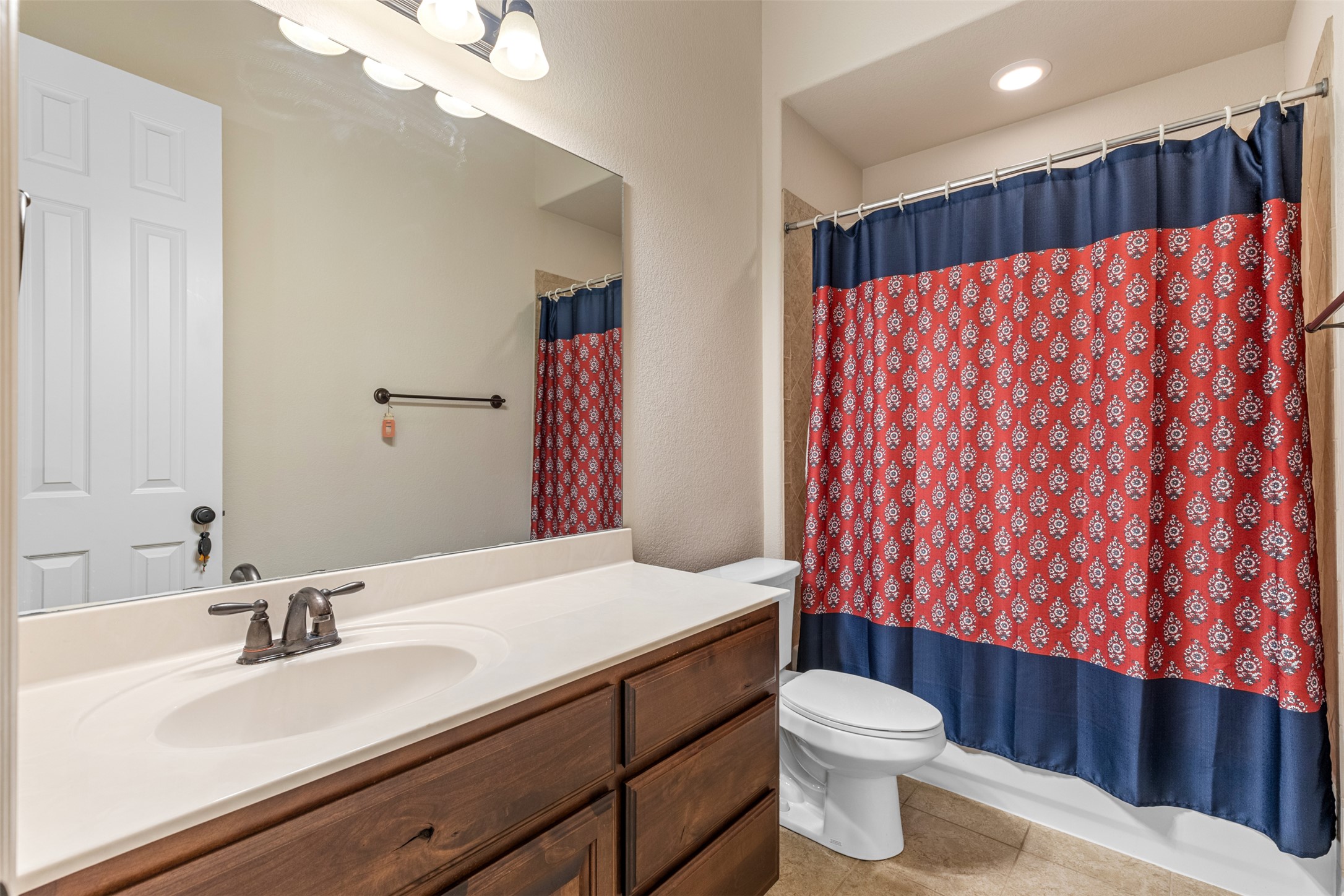 1916 Buffalo Speedway Leander, TX 78641 - Photo 25 of 31 a bathroom with a sink a toilet and shower curtain