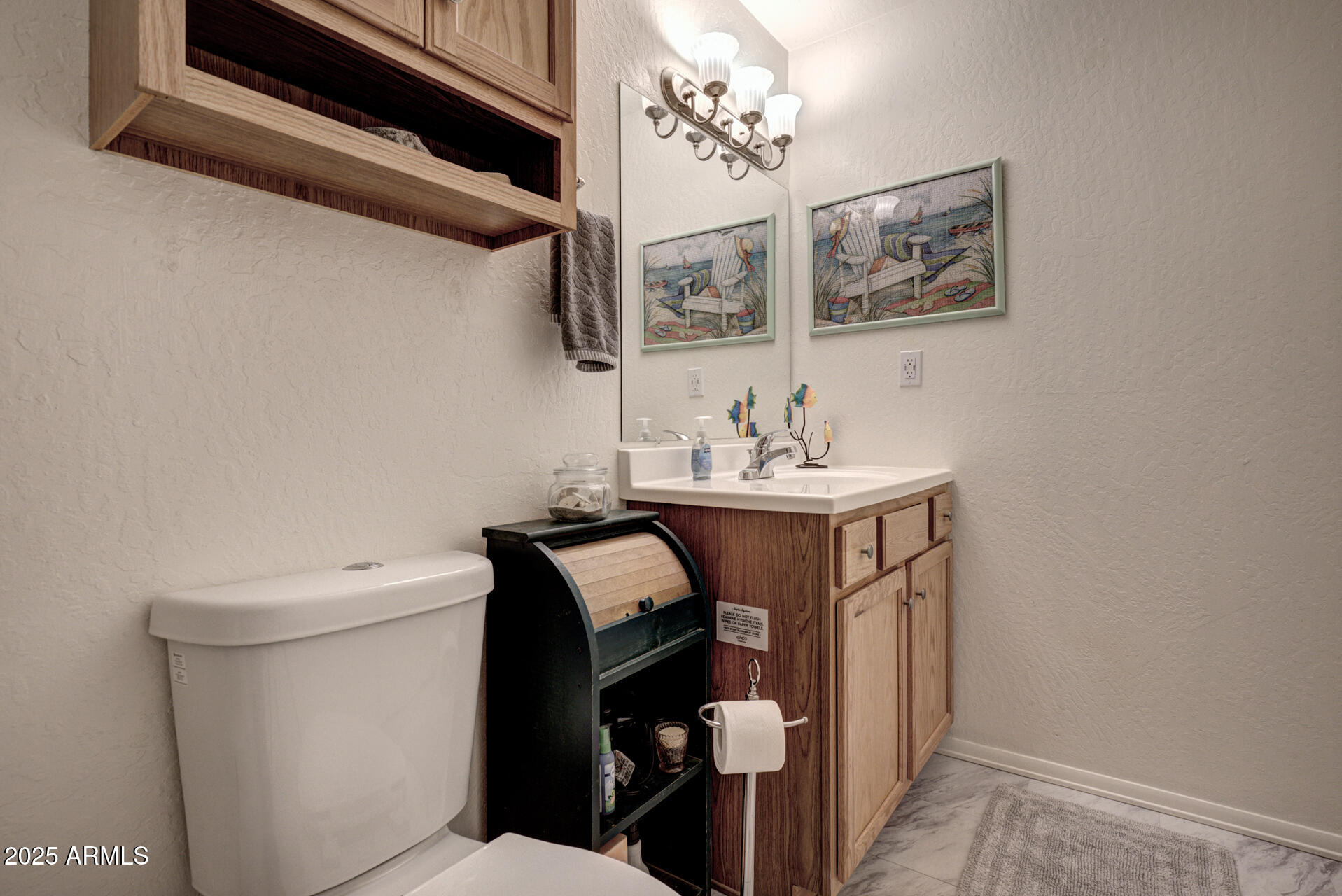 9019 Pinon Lane Pine, AZ 85544 - Photo 17 of 34 a bathroom with a sink a toilet and mirror