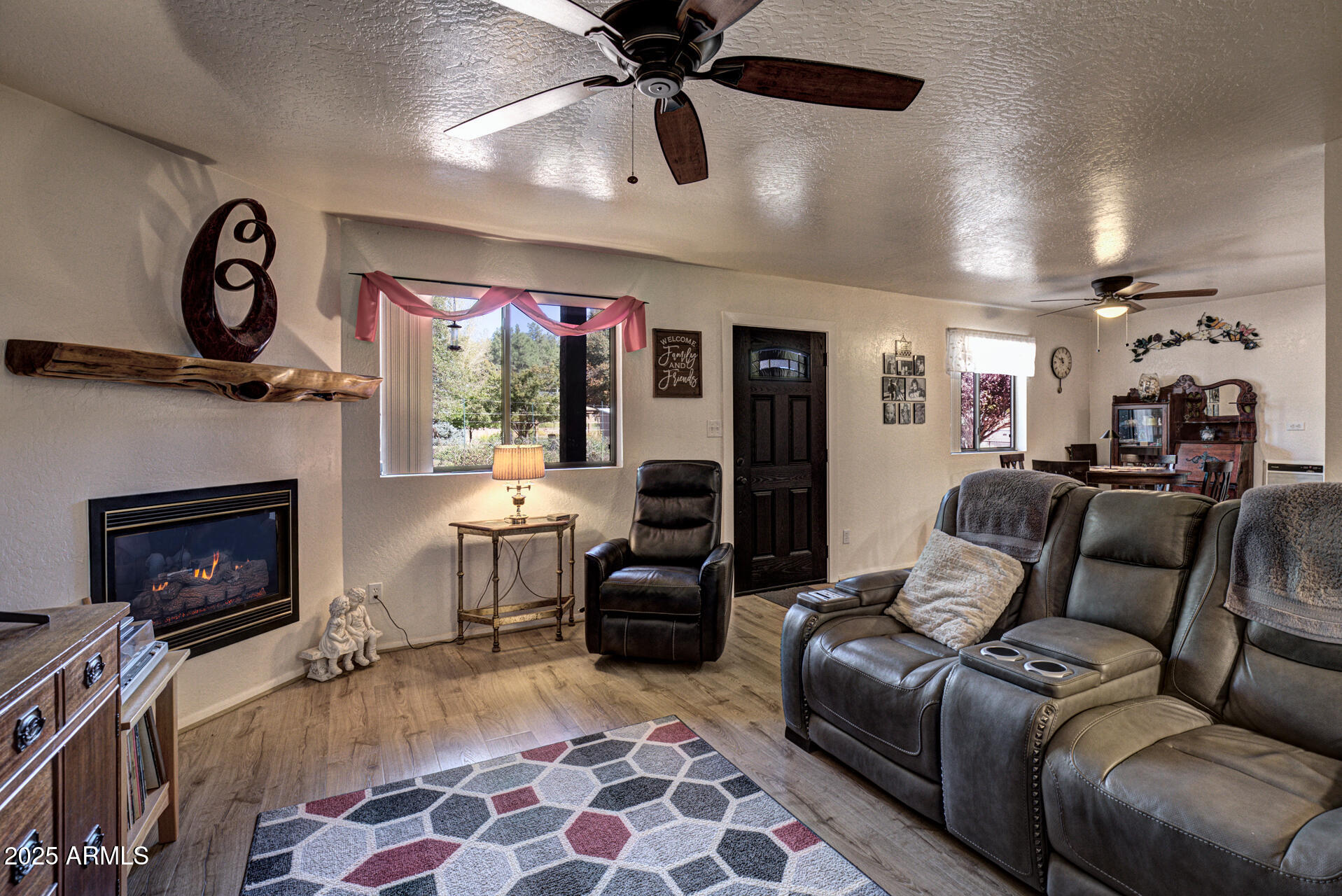 9019 Pinon Lane Pine, AZ 85544 - Photo 2 of 34 a living room with furniture a flat screen tv and a fireplace