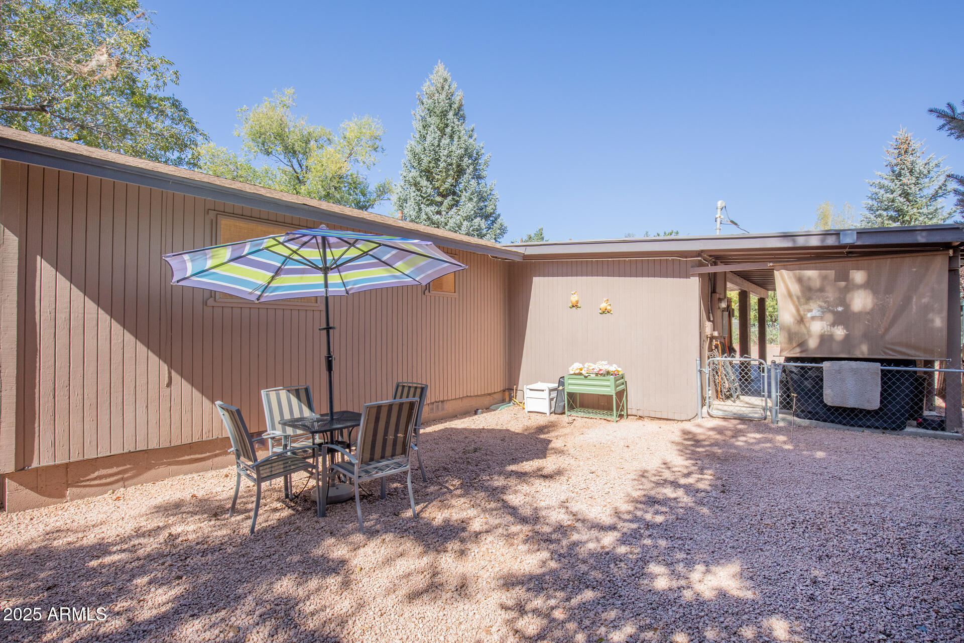 9019 Pinon Lane Pine, AZ 85544 - Photo 29 of 34 a view of a patio with a table and chairs under an umbrella